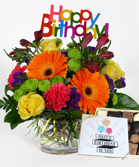 Cube filled with bright gerbera daisies, roses, carnations and more