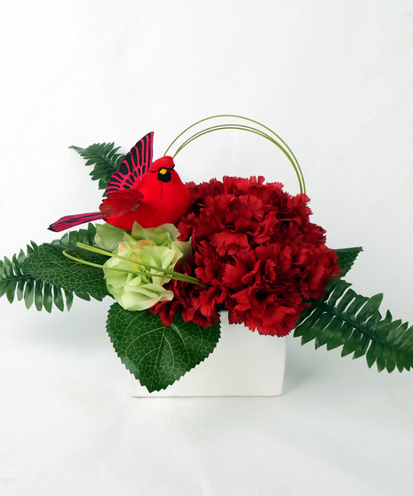 red carnations with a red cardinal decoration
