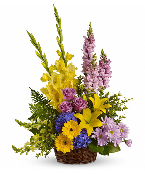 Sympathy basket of yellow and purple flowers and greenery