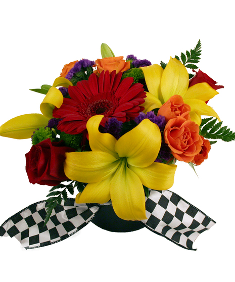 Image showcases the Finish Line Floral Arrangement, featuring a vibrant mix of summer flowers arranged in a low round cylinder vase completed with checkered flag ribbon