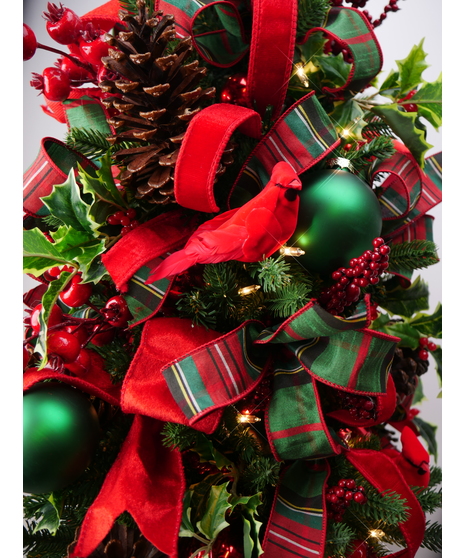 This  artificial tree is beautifully hand-decorated with red and green accessories and ribbon