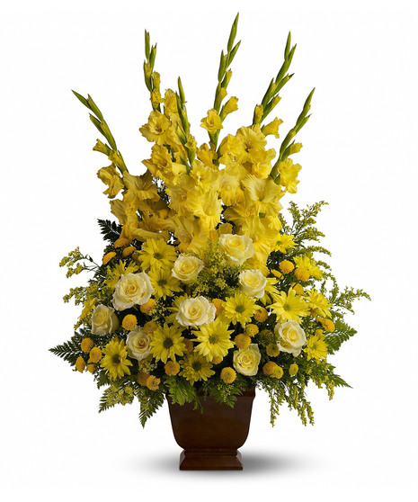 Bright yellow flowers presented in a sympathy urn