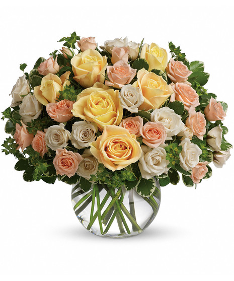 Bubble bowl vase filled with pastel roses and greenery