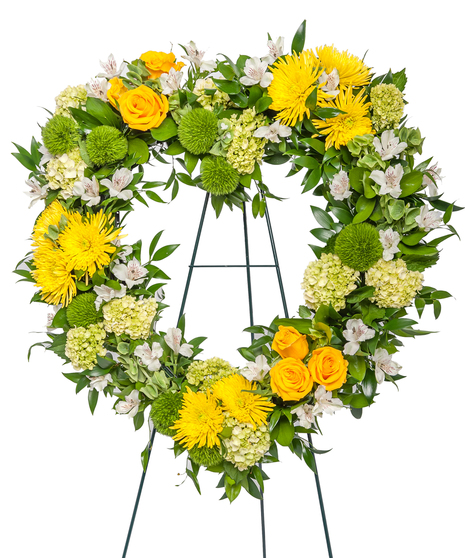 A heart-shaped floral arrangement made of vibrant hydrangeas, roses, and alstroemeria, with mixed greenery, displayed against a white background.