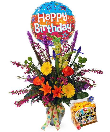 Bright bouquet of flowers in a blue vase presented with a balloon that reads 