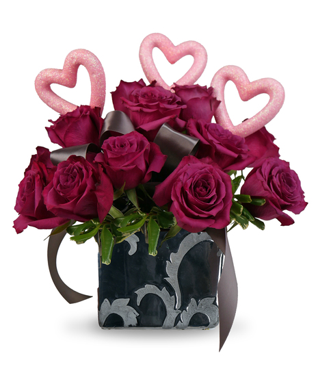 A dozen Blueberry roses in a silver ceramic vase with heart accents.