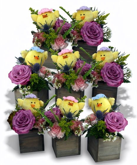 Set of three Easter floral arrangements featuring plush yellow chicks surrounded by pink roses and spring flowers arranged in rustic wooden cube containers.